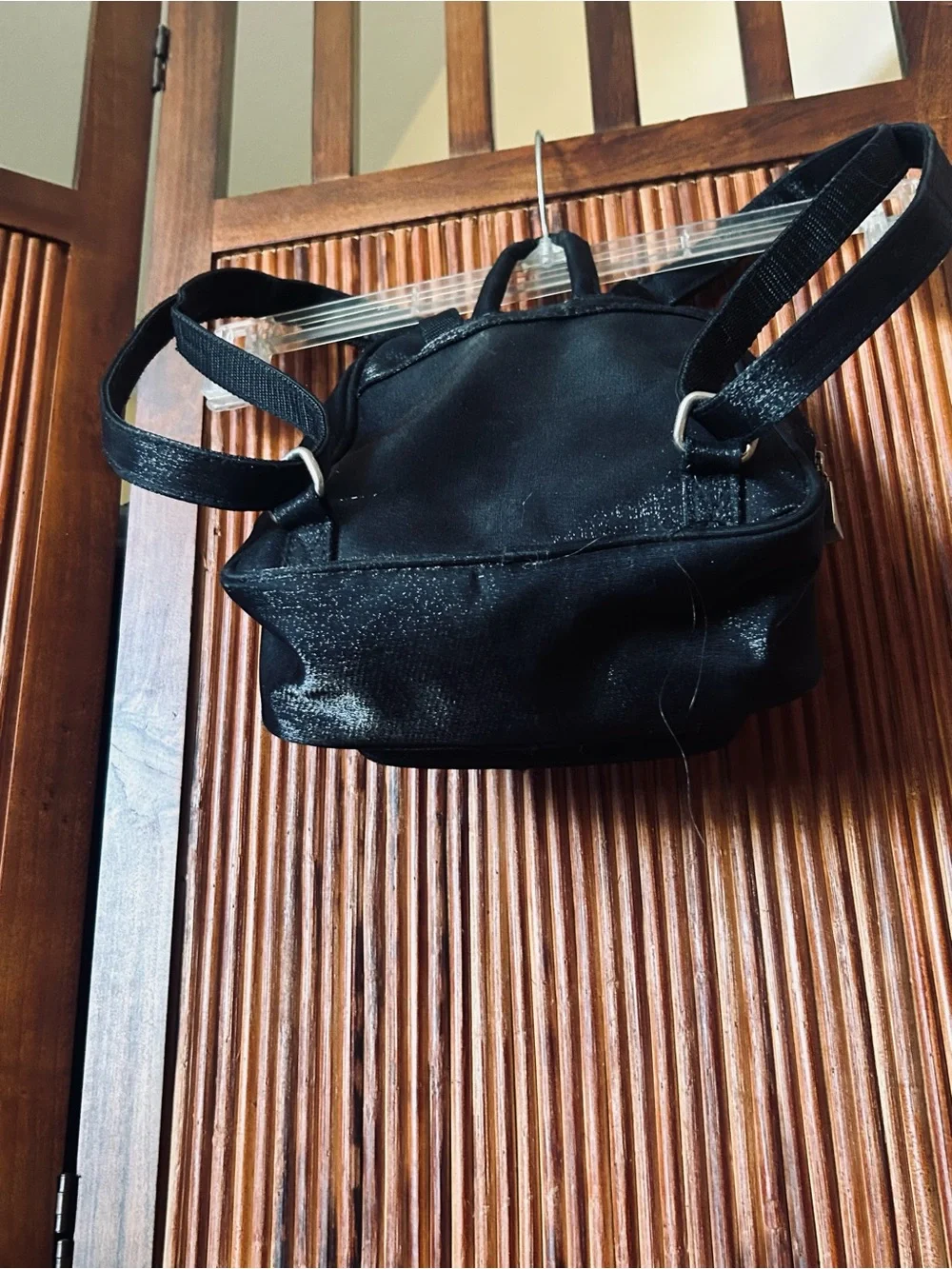 Backpack mini style. Black little purse with lots of compartments and zippers.